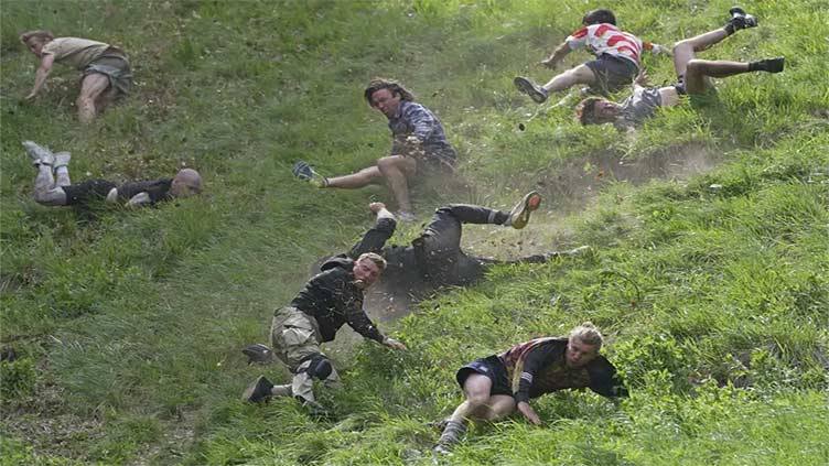 Rolling thunder: contestants chase cheese wheel down a hill in chaotic UK race